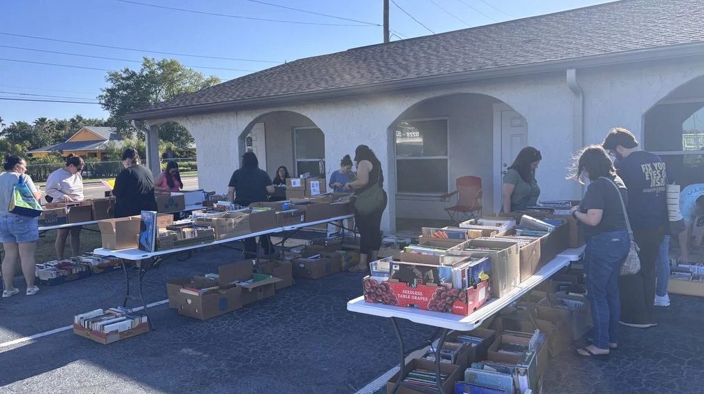 The lot outside our State Road 54 door in New Port Richey, set up with tables of books on a sale Saturday. On weekdays this is where you pull up to drop books off.